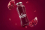 Glasflasche mit Zamba-Logo als Beispiel für eine geile Handelsmarke – Wort-Bild-Marke in Weiss auf tiefrotem Hintergrund mit Granatapfelstücken.