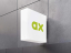 Wandmontierte Leuchtkastenwerbung mit abonax Logo in grün, auf einer grauen Betonwand. Logodesign by we dot Design Agentur