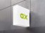 Wandmontierte Leuchtkastenwerbung mit abonax Logo in grün, auf einer grauen Betonwand. Logodesign by we dot Design Agentur
